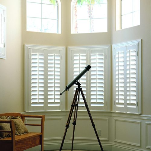 Woodlore Shutters, outside mount, 3" ridge Deco frame, 4-1/2" louvers, silk white finish.